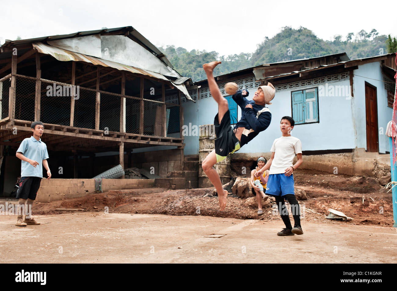 Teenage boys playing a game of Sepak takraw in the Mae La refugee camp, Tak province, Thailand, Asia. Stock Photo