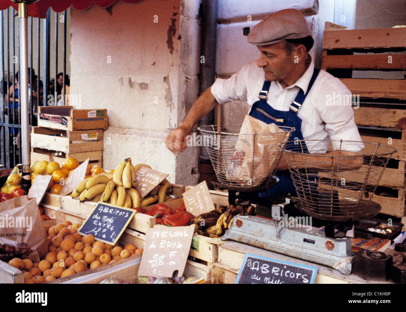 Fruit seller at market stall in Miramont, France. Stock Photo