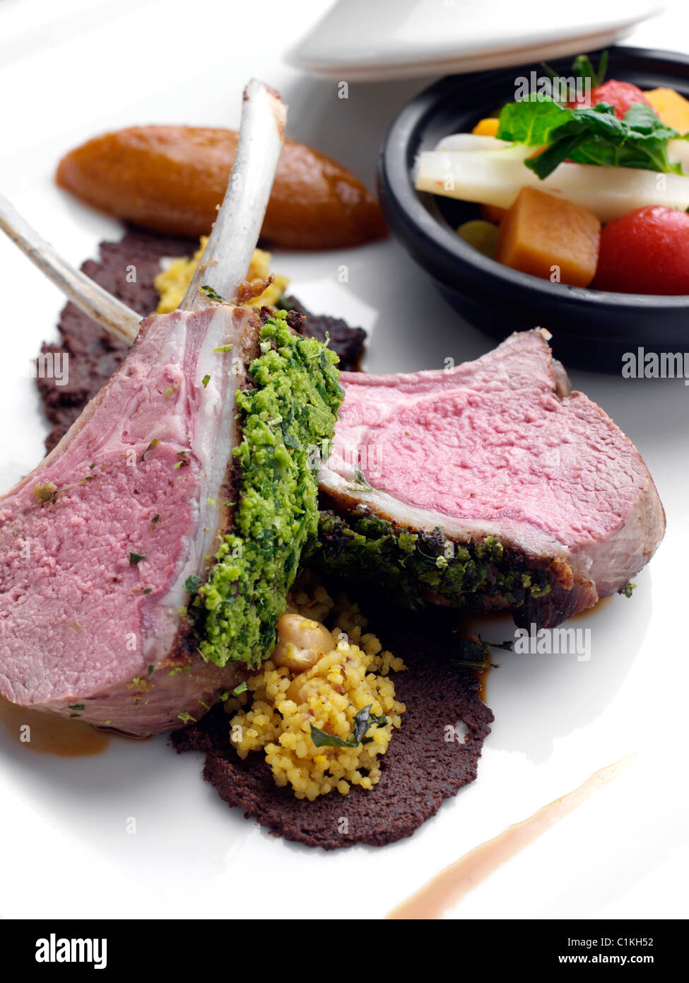 Herb crust Morrocan lamb chops with vegetable tagine Stock Photo Alamy