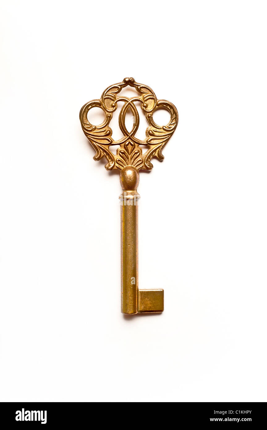 ornate antique golden skeleton key isolated Stock Photo