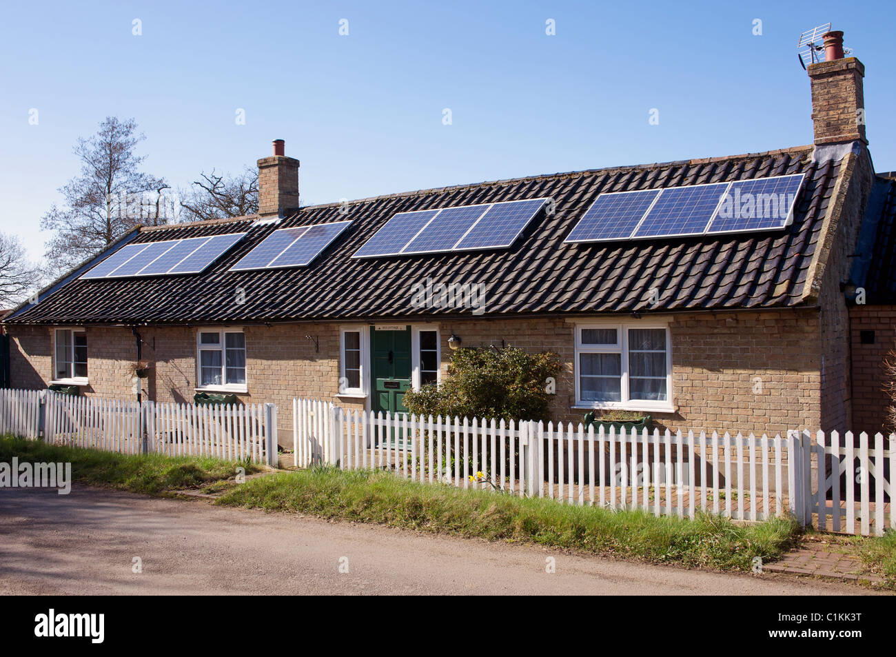 Bungalow fitted with solar panels on roof Stock Photo