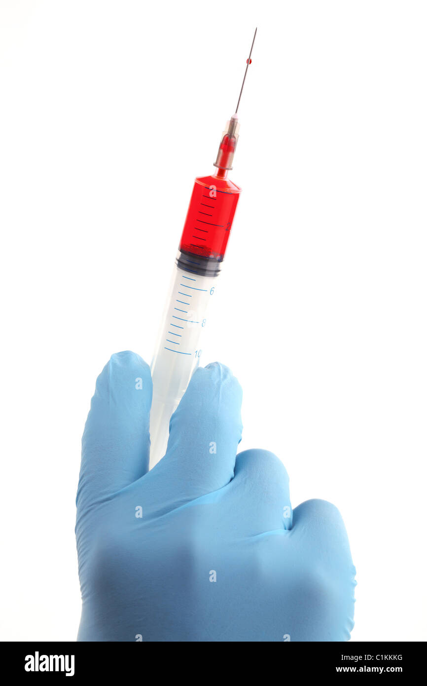 Doctor hand with medical syringe, ready for injection .. Stock Photo