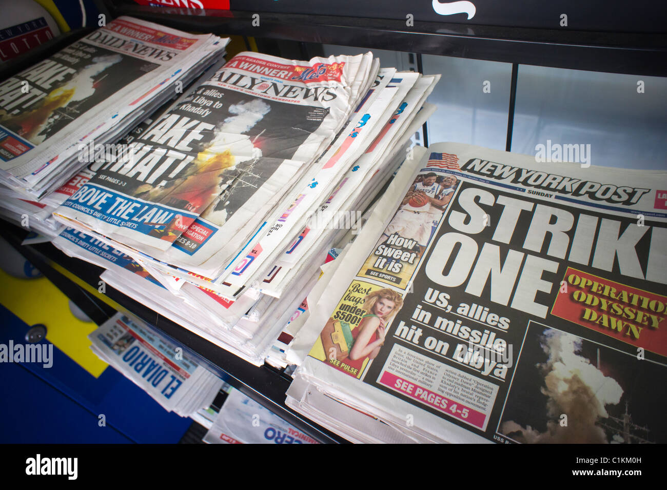 Headlines of New York newspapers on a news stand on the Operation Odyssey Dawn in Libya Stock Photo