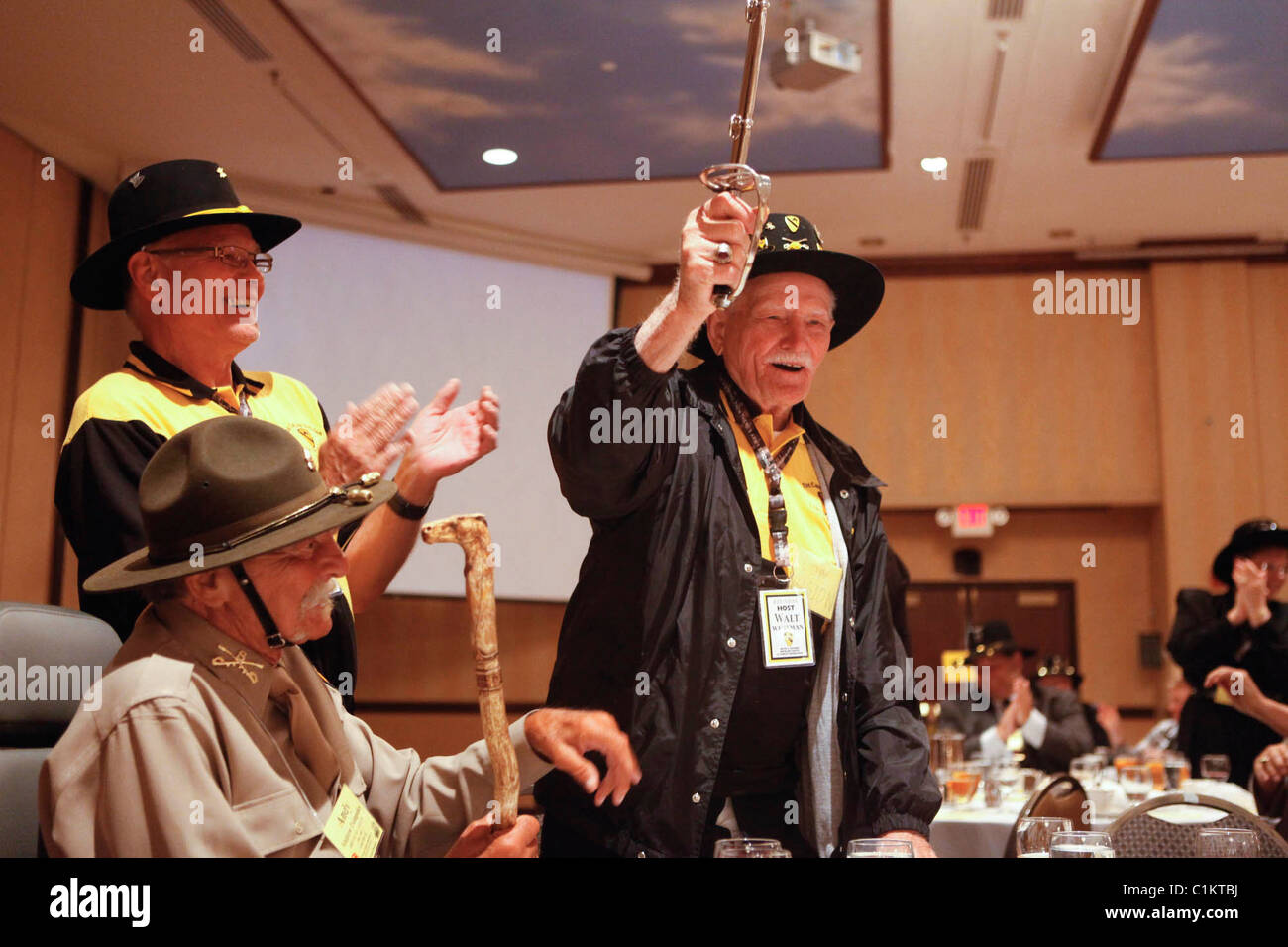 Walter Westman, who is 100-years old, picks up a Cavalry Saber while celebrating his birthday First Cavalry Division reunion. Stock Photo