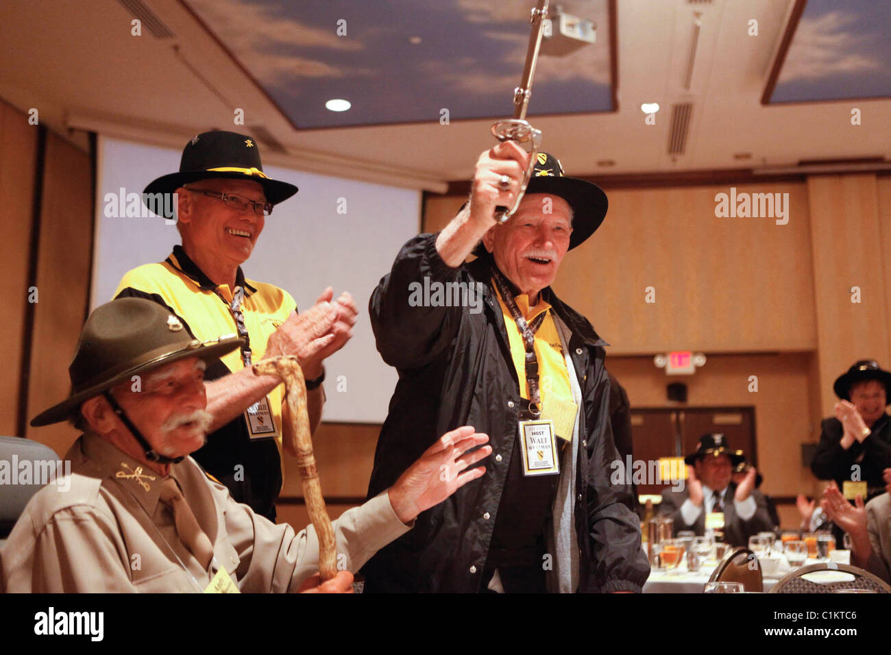 Walter Westman, who is 100-years old, picks up a Cavalry Saber while celebrating his birthday First Cavalry Division reunion. Stock Photo