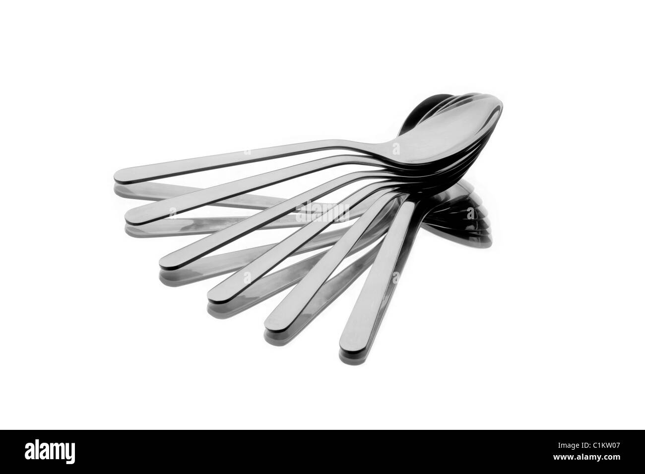 Six spoons spread as a fan on reflecting background Stock Photo