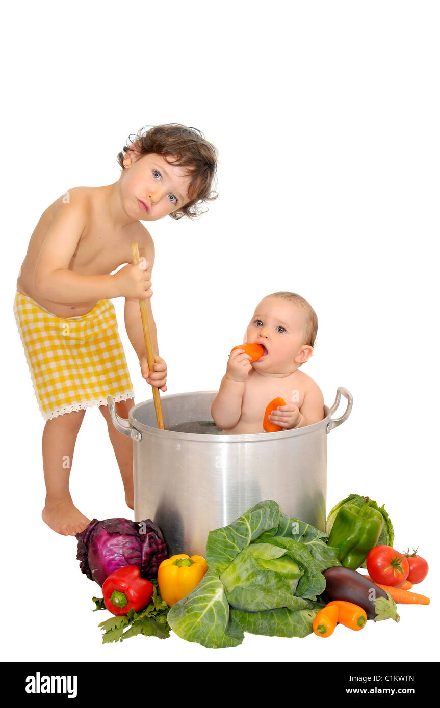 Beautiful young baby in a pan and boy cooking Stock Photo