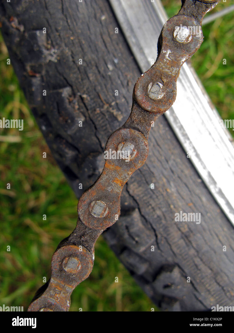 rusty bike chain and perished tire Stock Photo