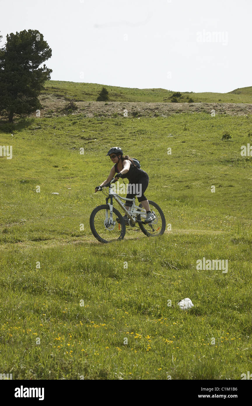 Girl on mountain bike in French Alps resort of La Plagne the village