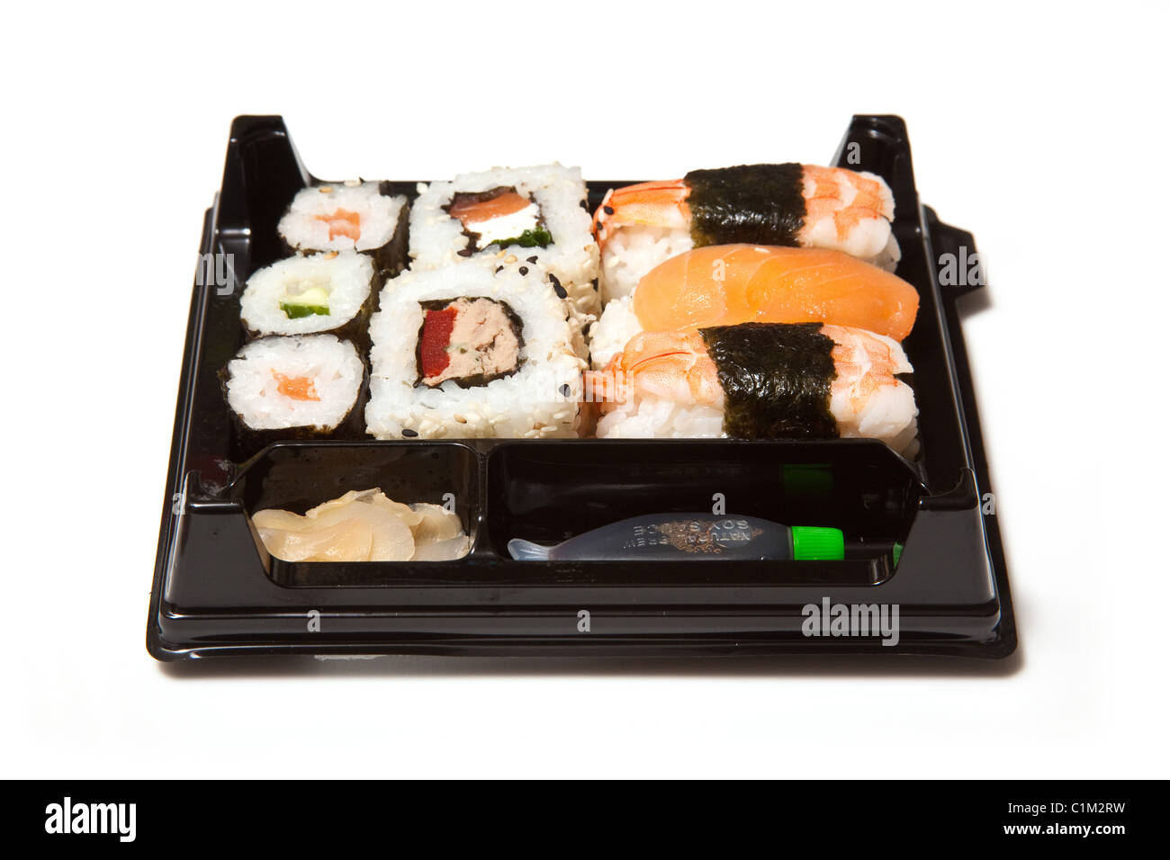 Sushi takeaway tray isolated on a white studio background. Stock Photo