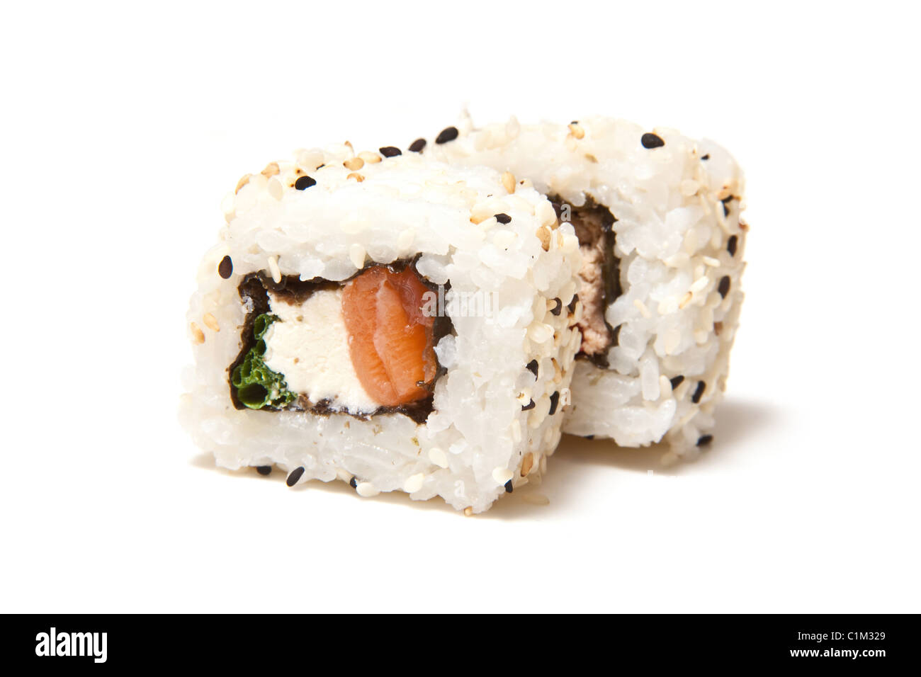 Salmon and cream cheese sushi roll isolated on a white studio background. Stock Photo