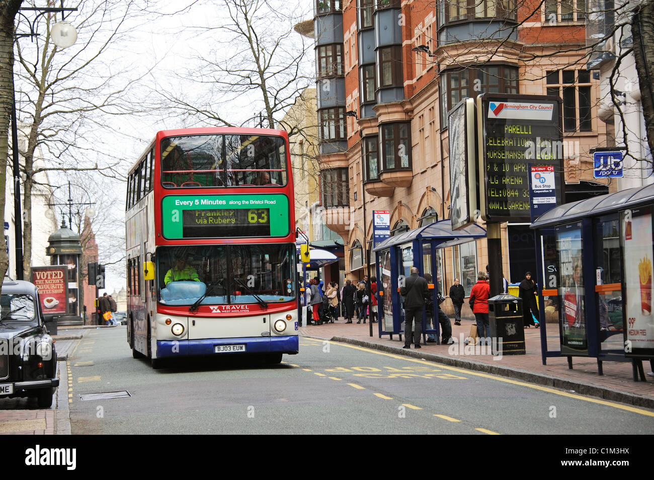 Bus stop and waiting passengers on Corporation Street in city centre