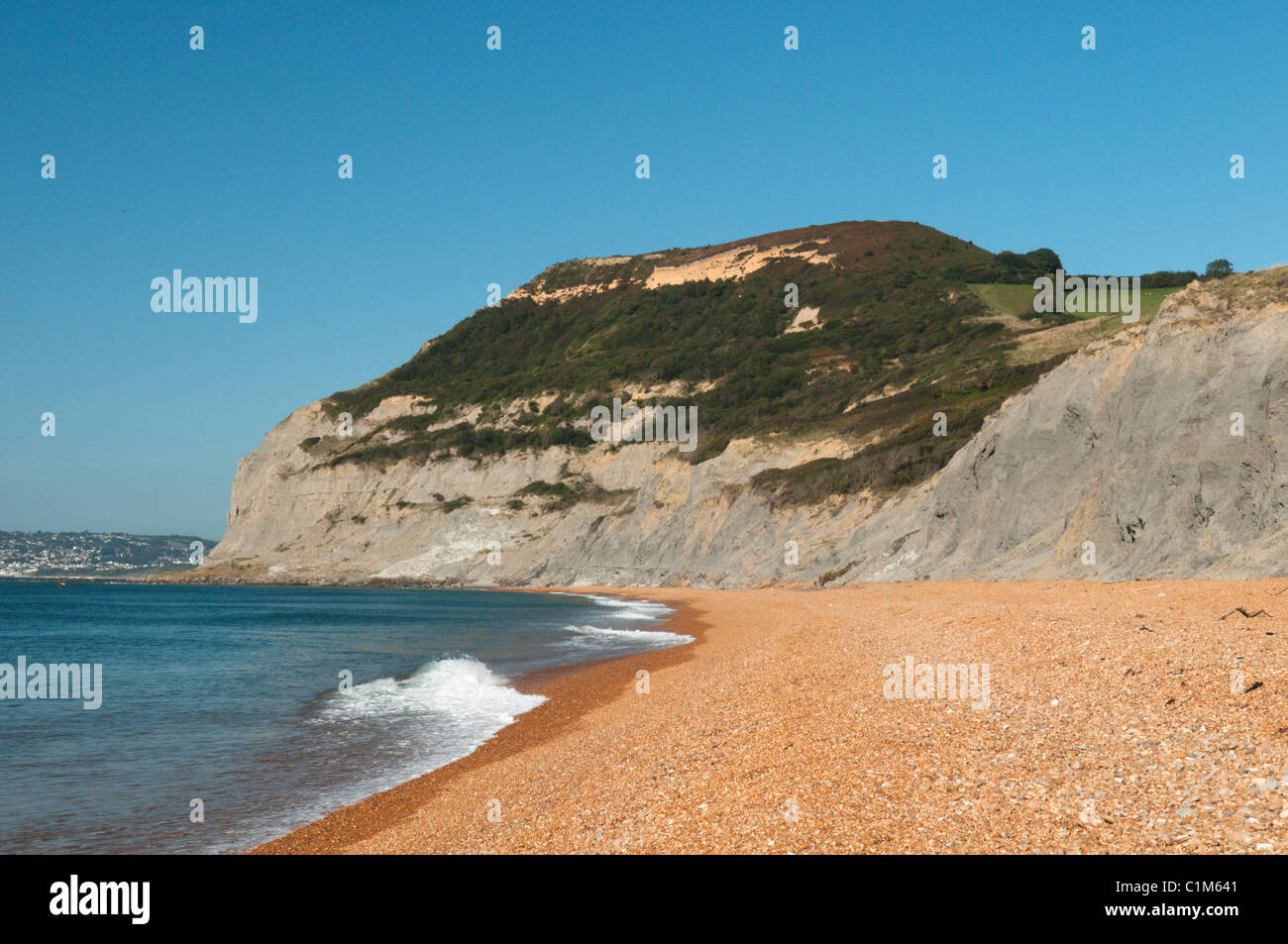 The pea-shingle beach at Seatown, Near Bridport, Dorset, UK. View west to Golden Cap, hill capped with greensand rock. Stock Photo