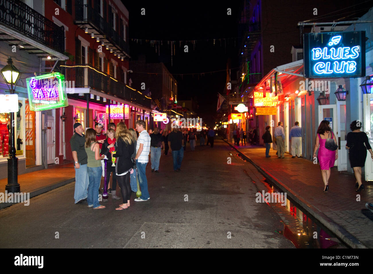 Neon signs of bars and restaurants along Bourbon Street in the French Quarter of New Orleans
