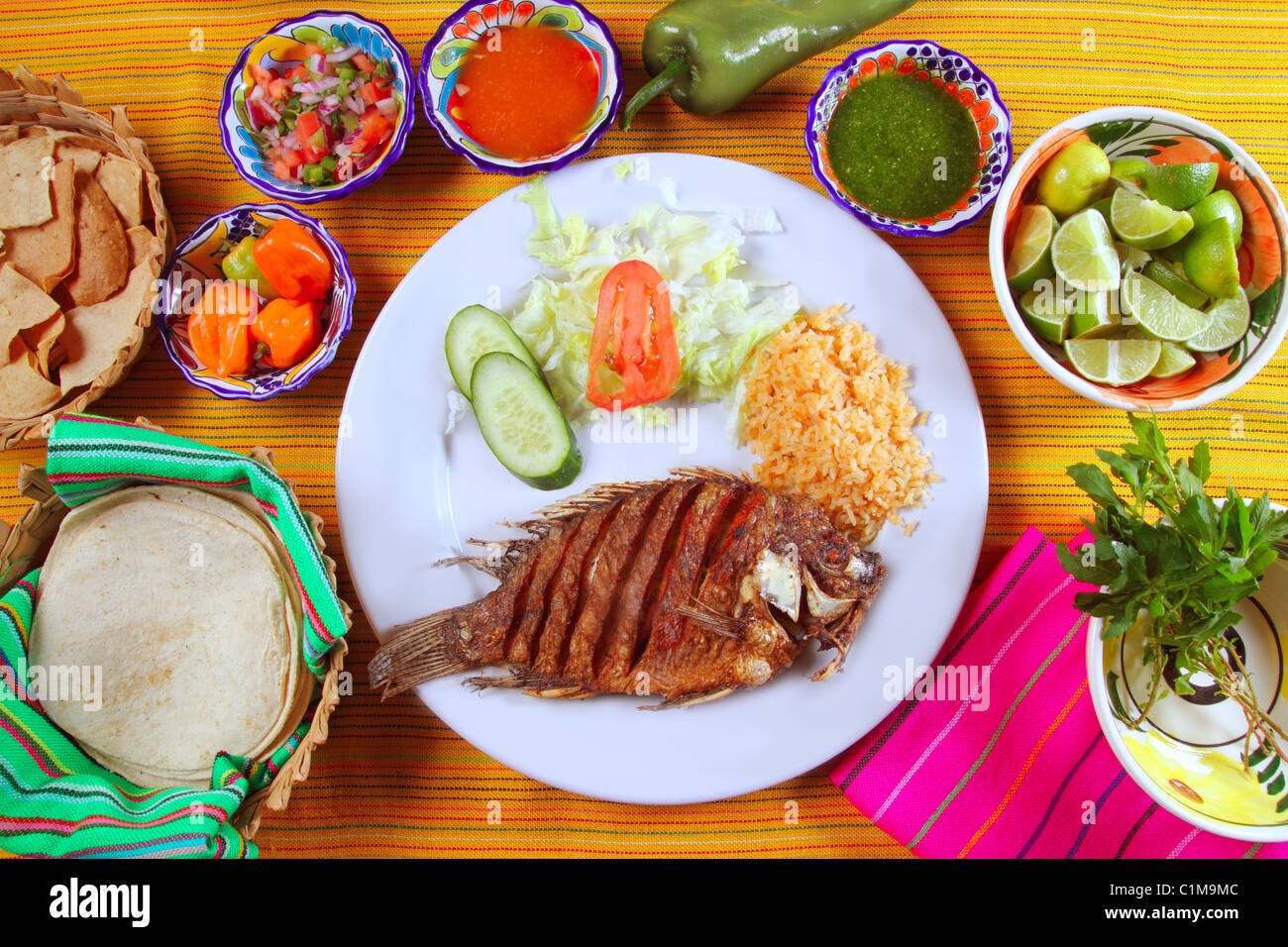 fried mojarra tilapia fish Mexico style with chili sauce and nachos
