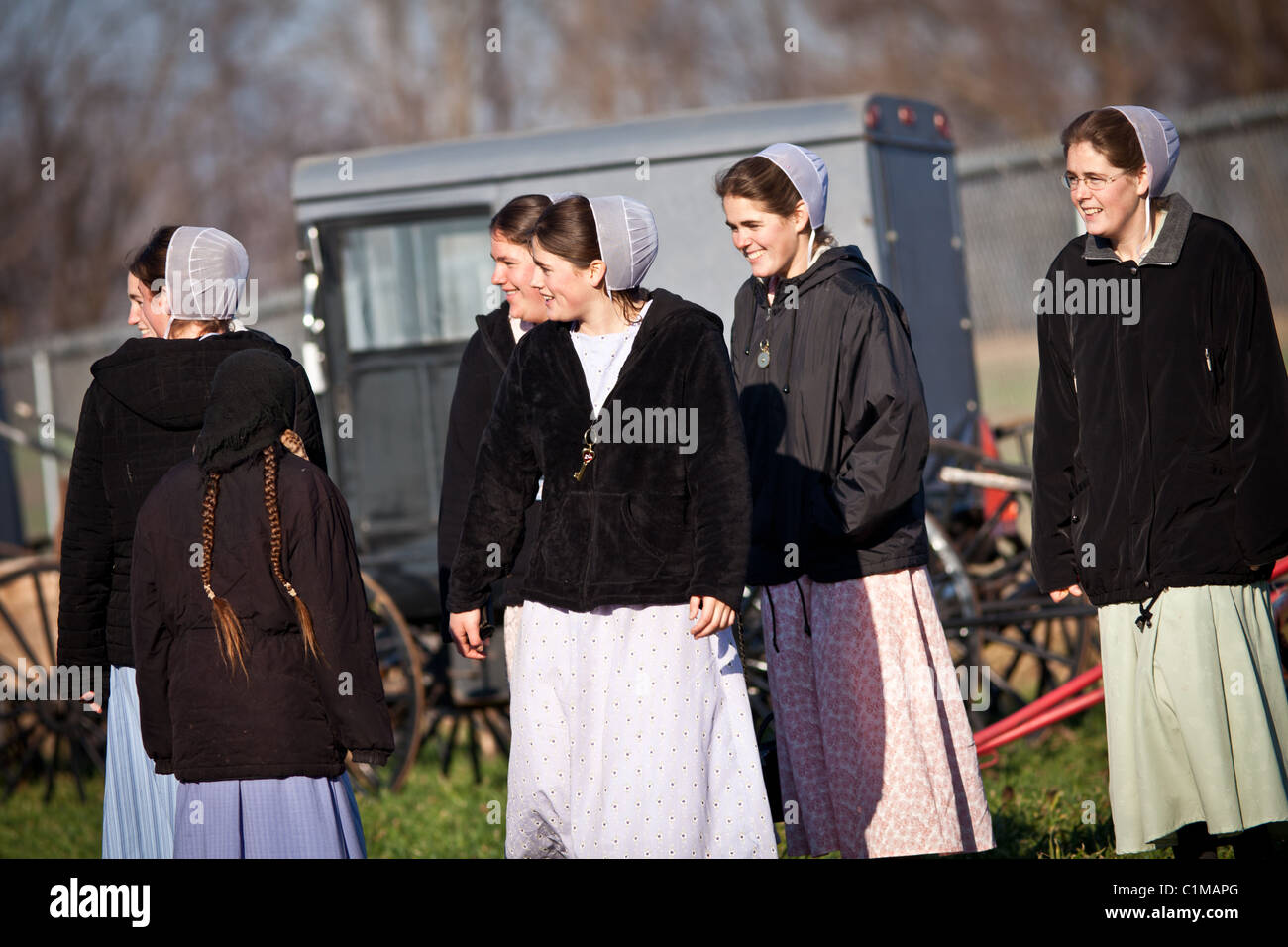 Amish girls laugh at the Annual Mud Sale to support the Fire Department in Gordonville, PA. Stock Photo