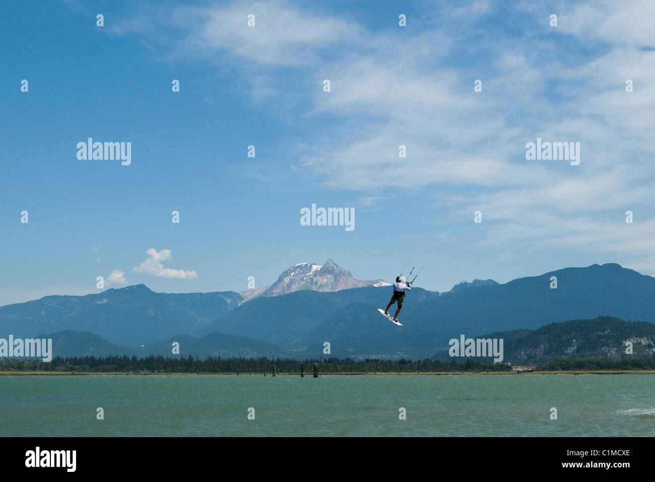 A kiteboarde is airborne at 'the Spit',Squamish, BC, Canada Stock Photo