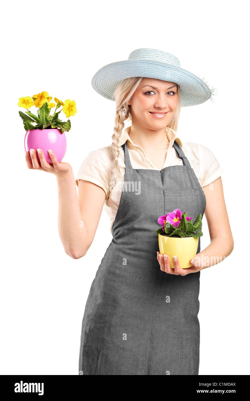 Smiling female gardener holding two potted plants Stock Photo - Alamy