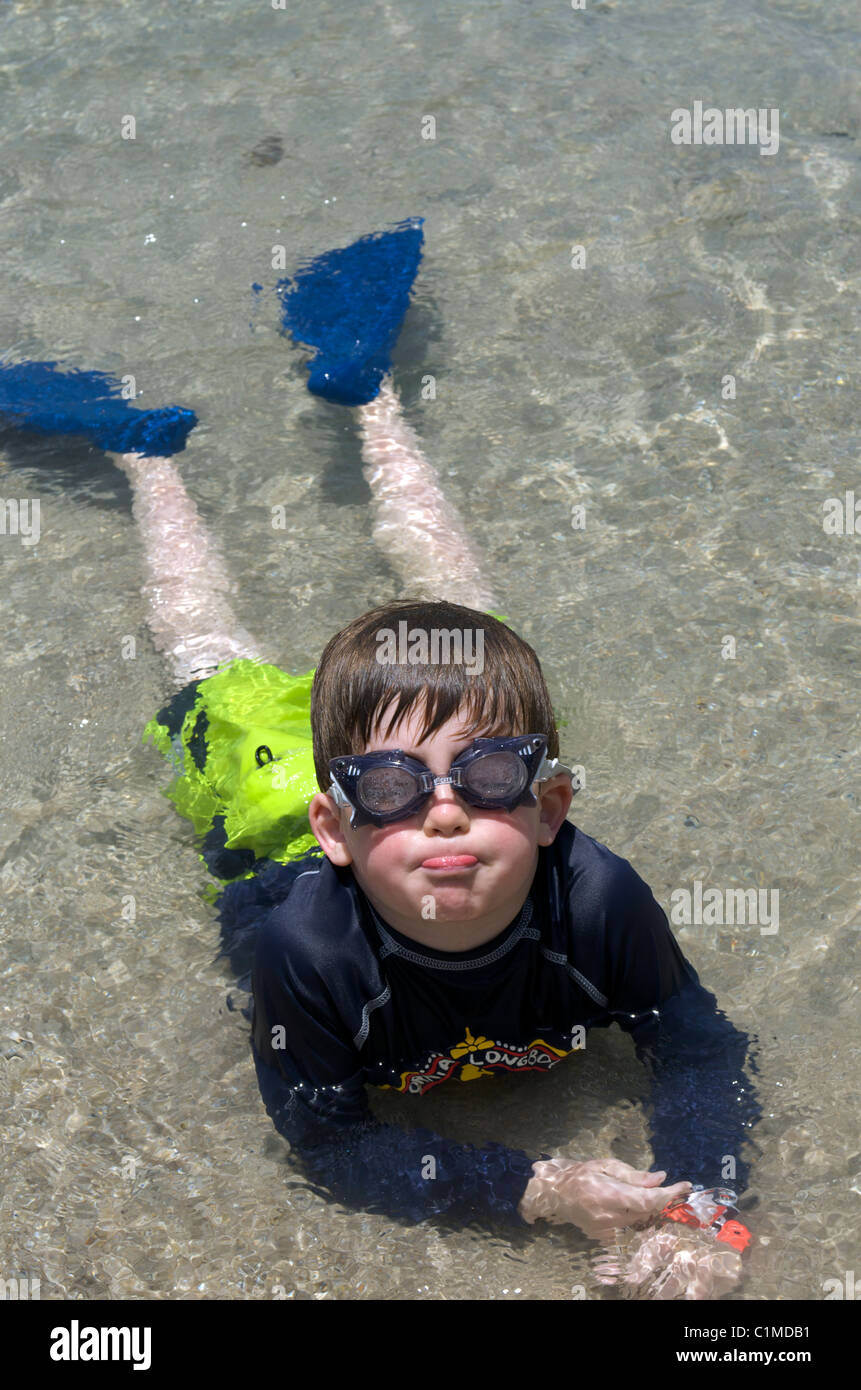 Funny face swimmer in goggles and flippers Stock Photo - Alamy