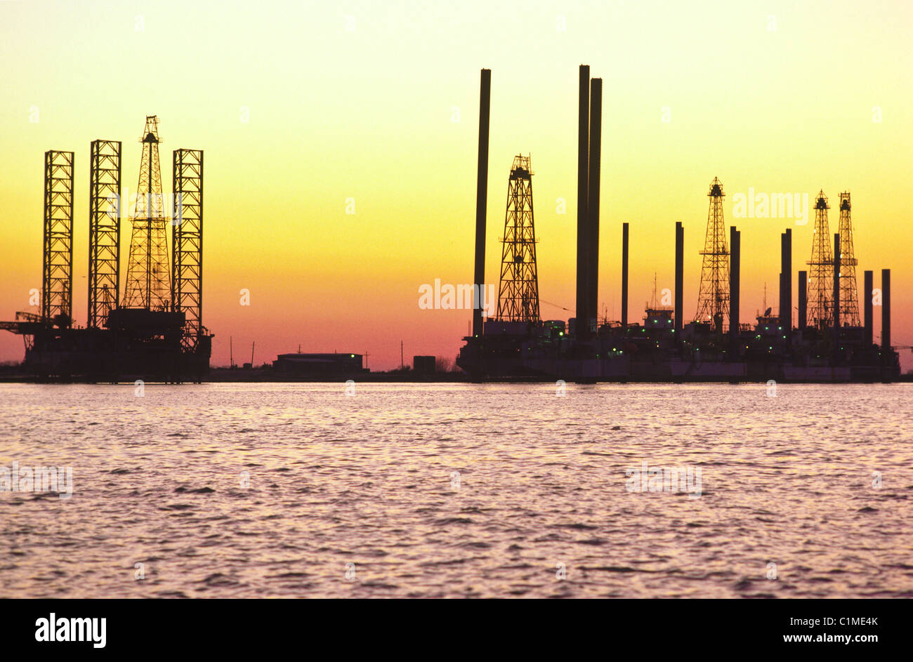 Idle offshore oil platforms being serviced before use in Sabine Pass, Texas, USA Stock Photo