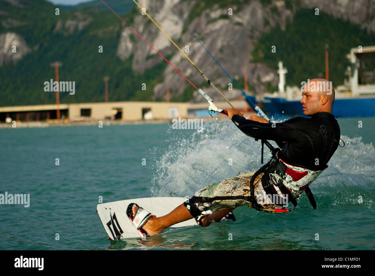 A kiteboarder catches the wind at 'the Spit', Squamish, BC, Canada Stock Photo