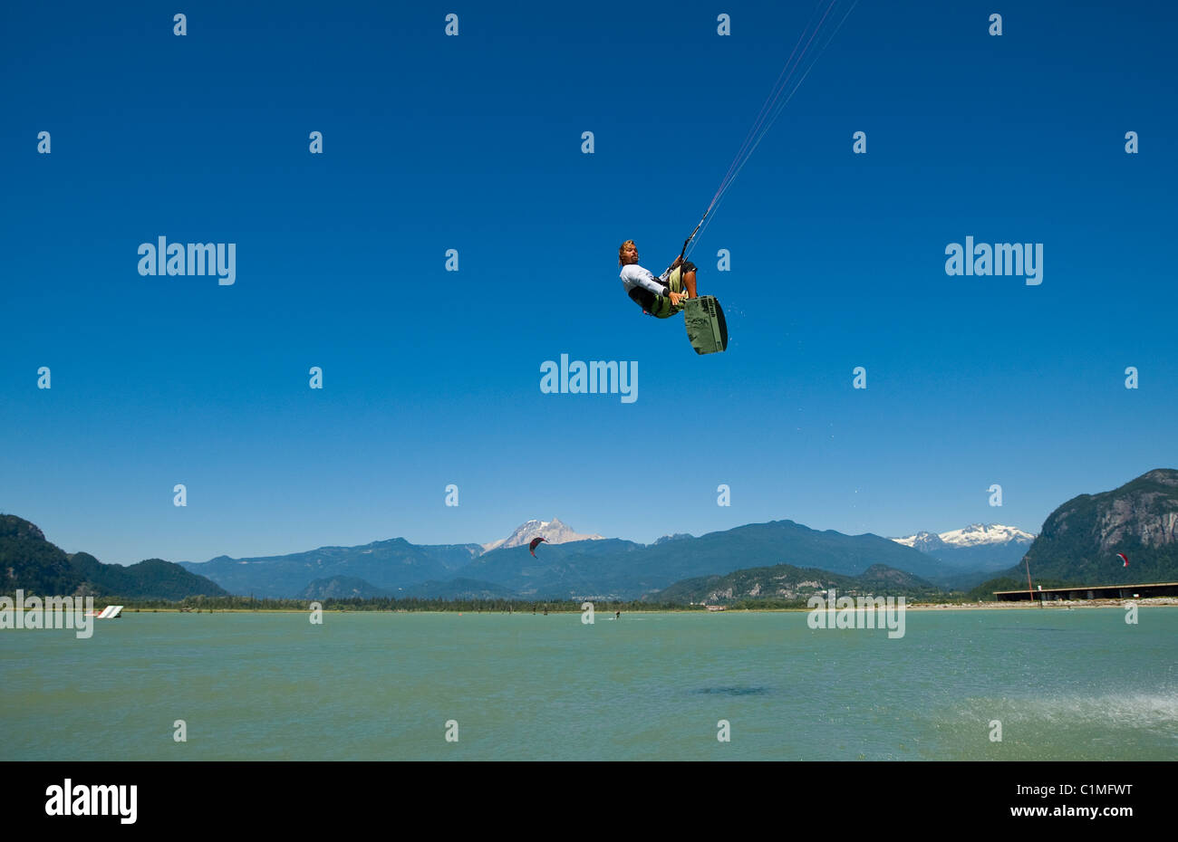 Airborne kiteboarder at 'the Spit', Squamish, BC, Canada. Stock Photo