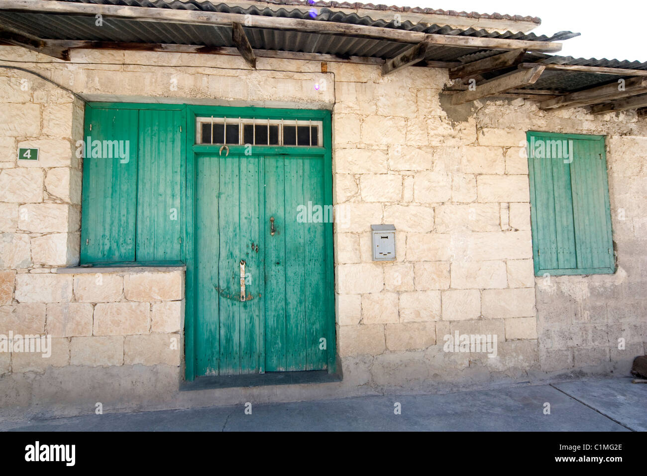 Green door on old building Stock Photo - Alamy