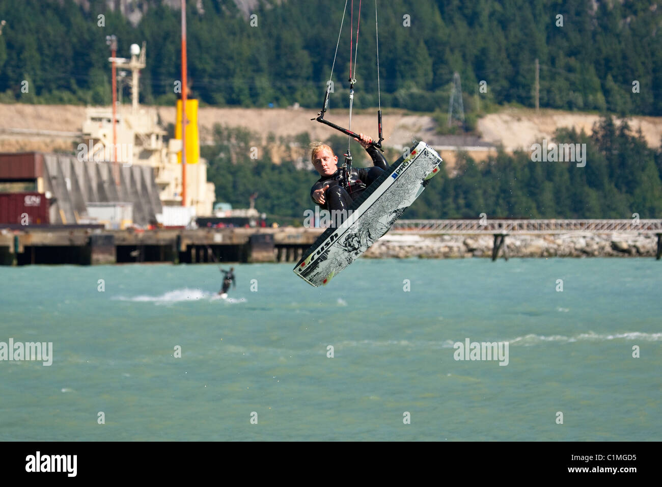 A kiteboarde is airborne at "the Spit",Squamish, BC, Canada Stock Photo