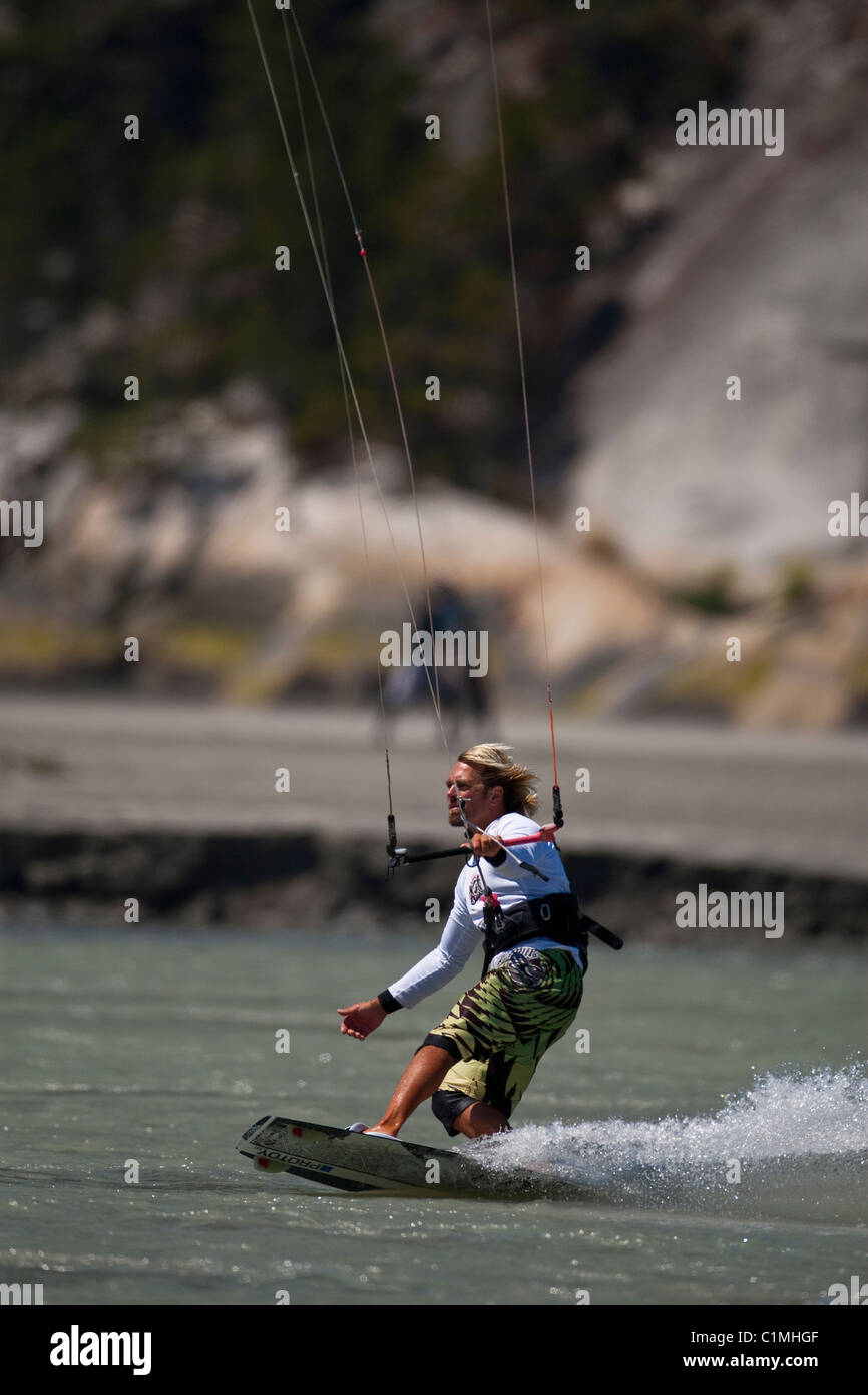 A kiteboarder catches the wind at 'the Spit' in Squamish, BC Stock Photo