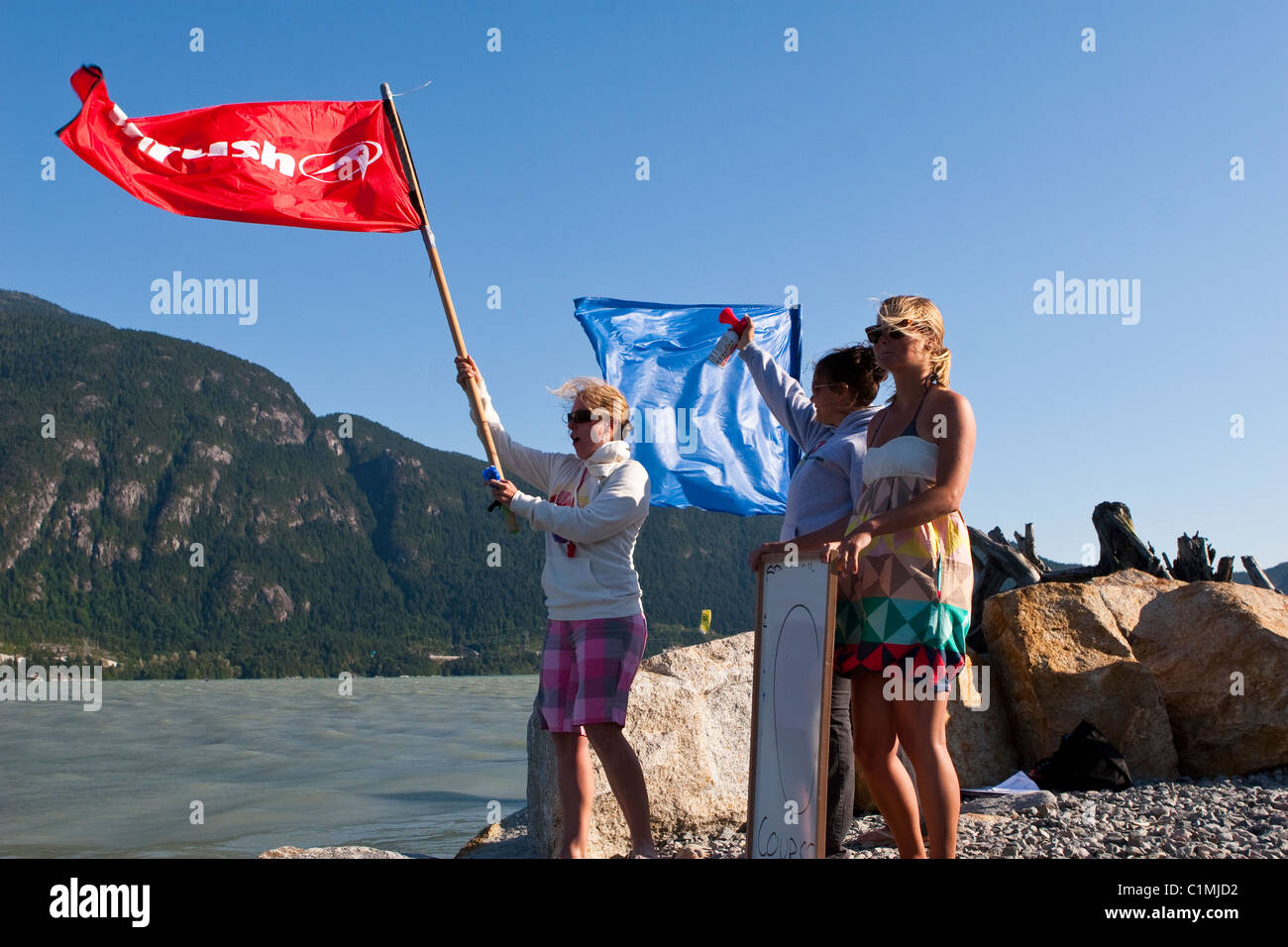 The red flag indicates the start of a kiteboard race. Stock Photo