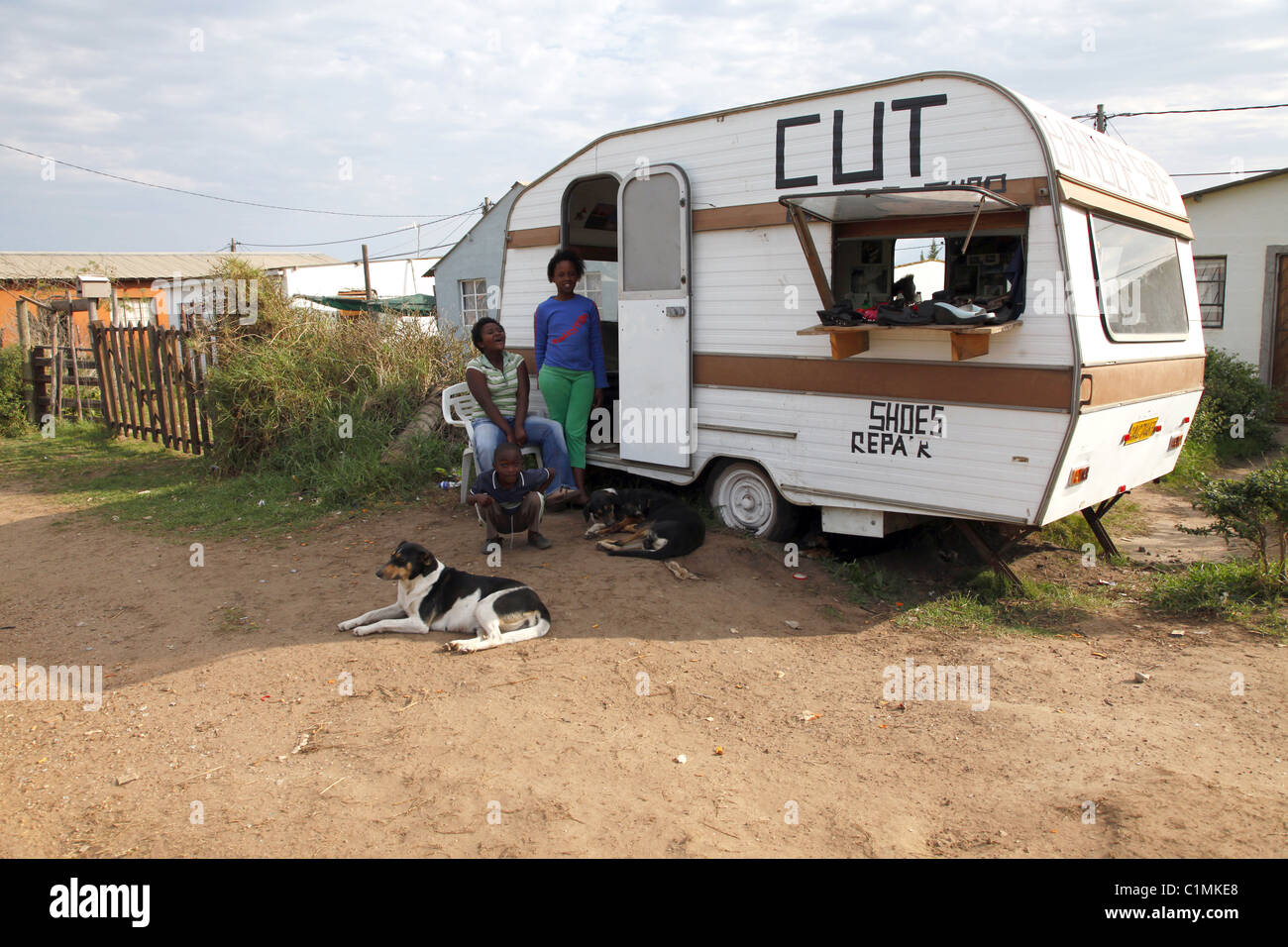 AFRICAN PEOPLE PEEP FROM CARAVAN KNYSNA TOWNSHIP SOUTH AFRICA 05 July 2011 Stock Photo