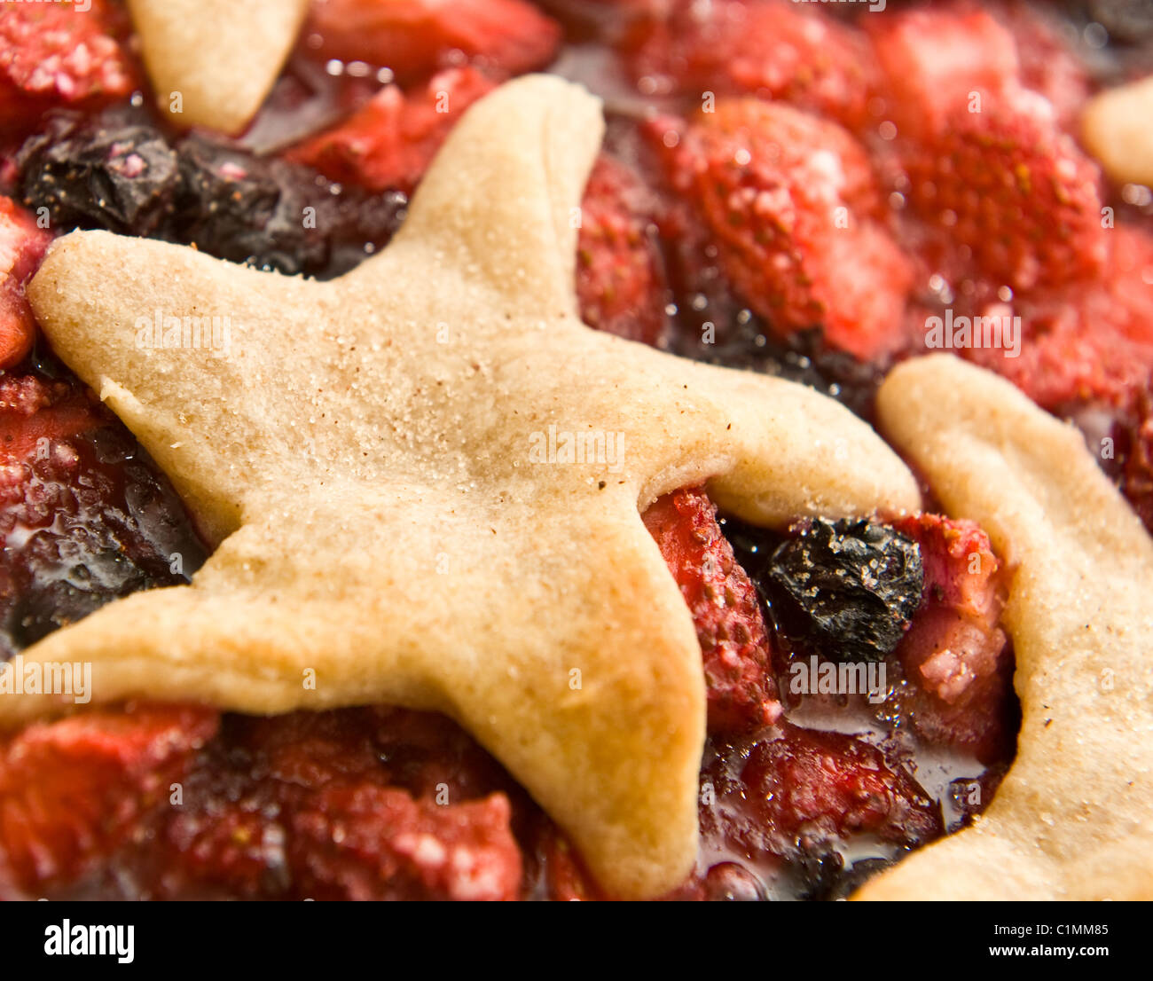 Close-up of a homemade strawberry and blueberry pie with star shaped pastry crust Stock Photo