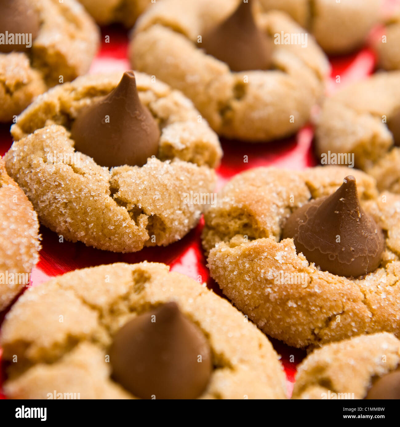 close-up of homemade peanut butter cookies with chocolate kisses and sugar sprinkles Stock Photo