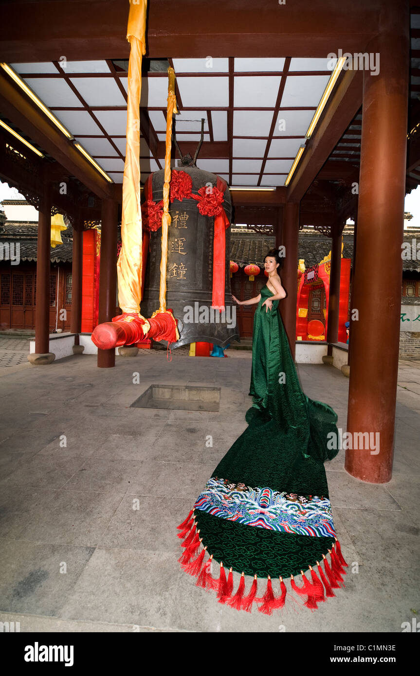 A model wearing a stunning Brocade dress designed by top designer Laurence Xu. Stock Photo