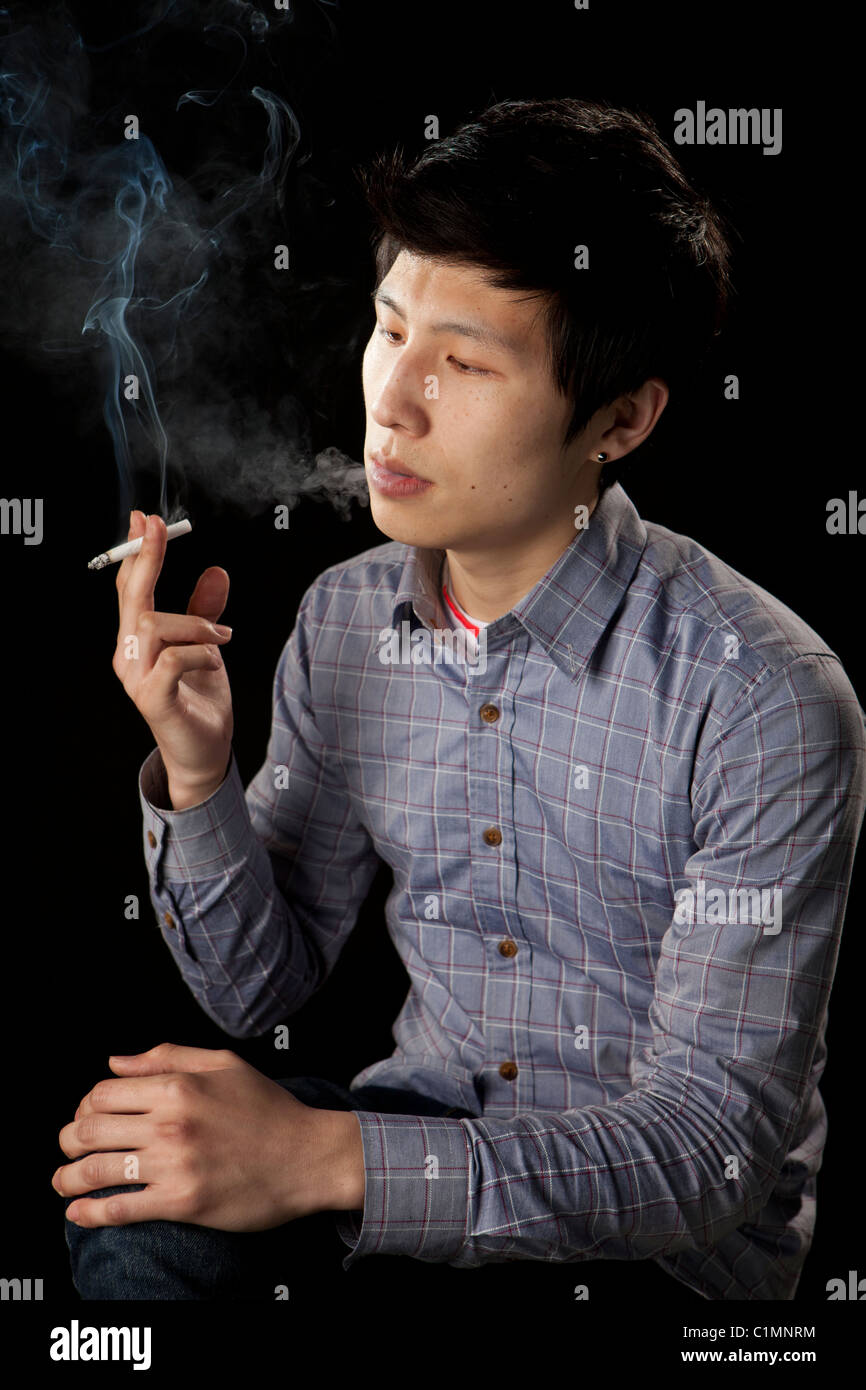tobacco reading University student reading book with smoking cigarette Stock Photo