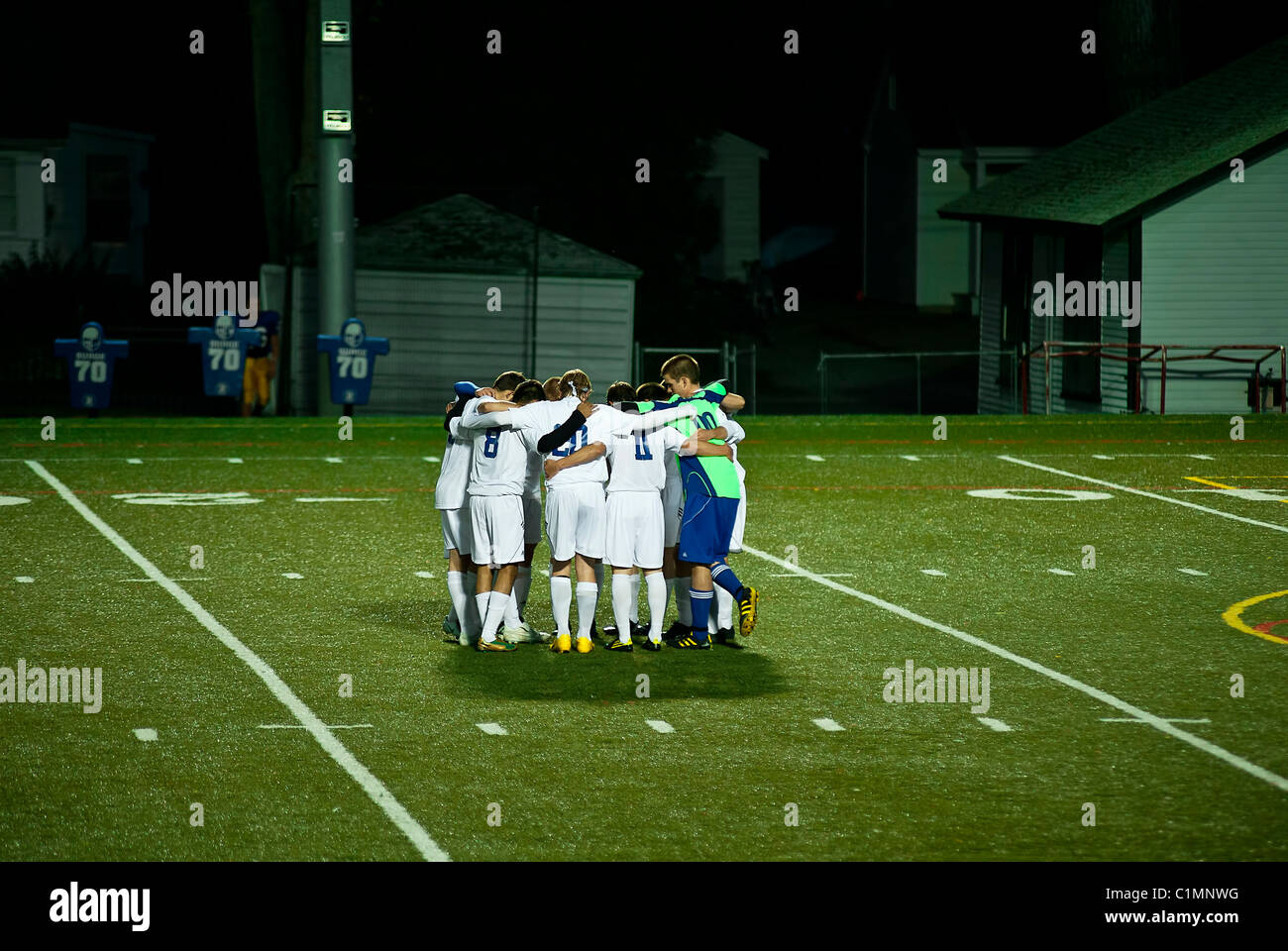 Soccer team huddles before match. Stock Photo