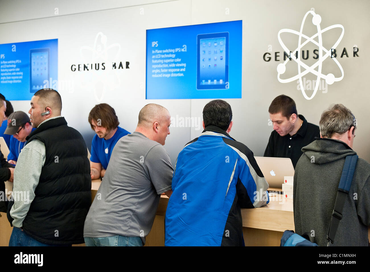 Customers explore the iPad in an Apple store on launch day, Cherry Hill Mall, New Jersey, USA. Stock Photo