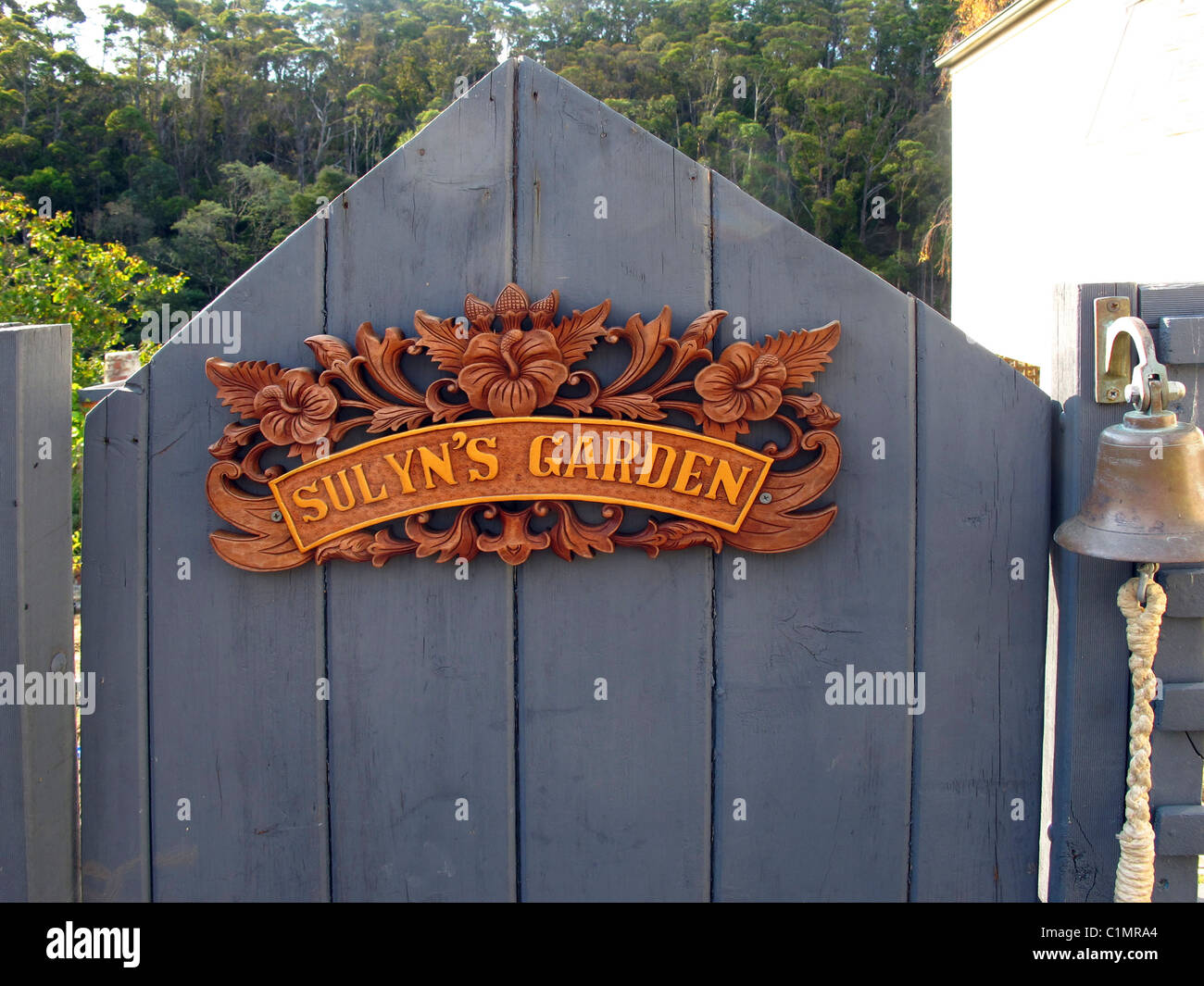 Garden gate with hand carved wooden sign made by Balinese wood carvers Stock Photo