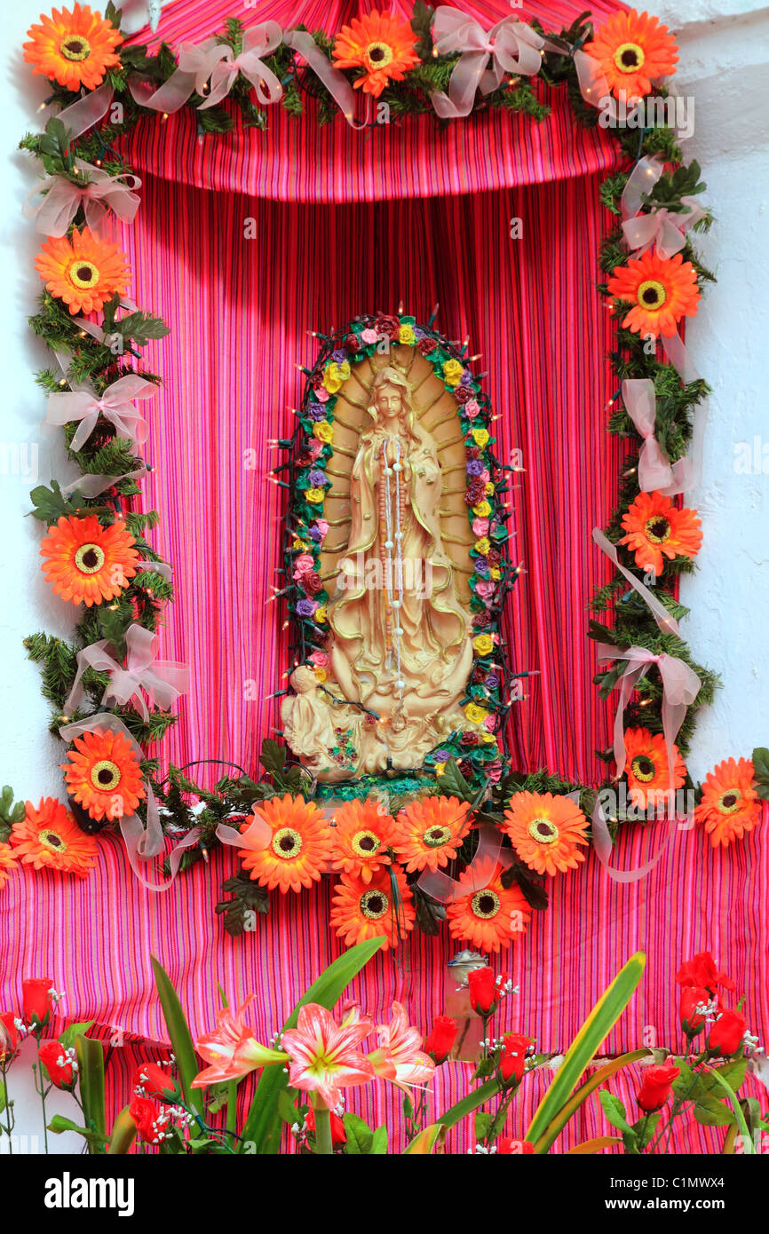 Mexican virgin madonna figure house facade tropical Caribbean Guadalupe Stock Photo