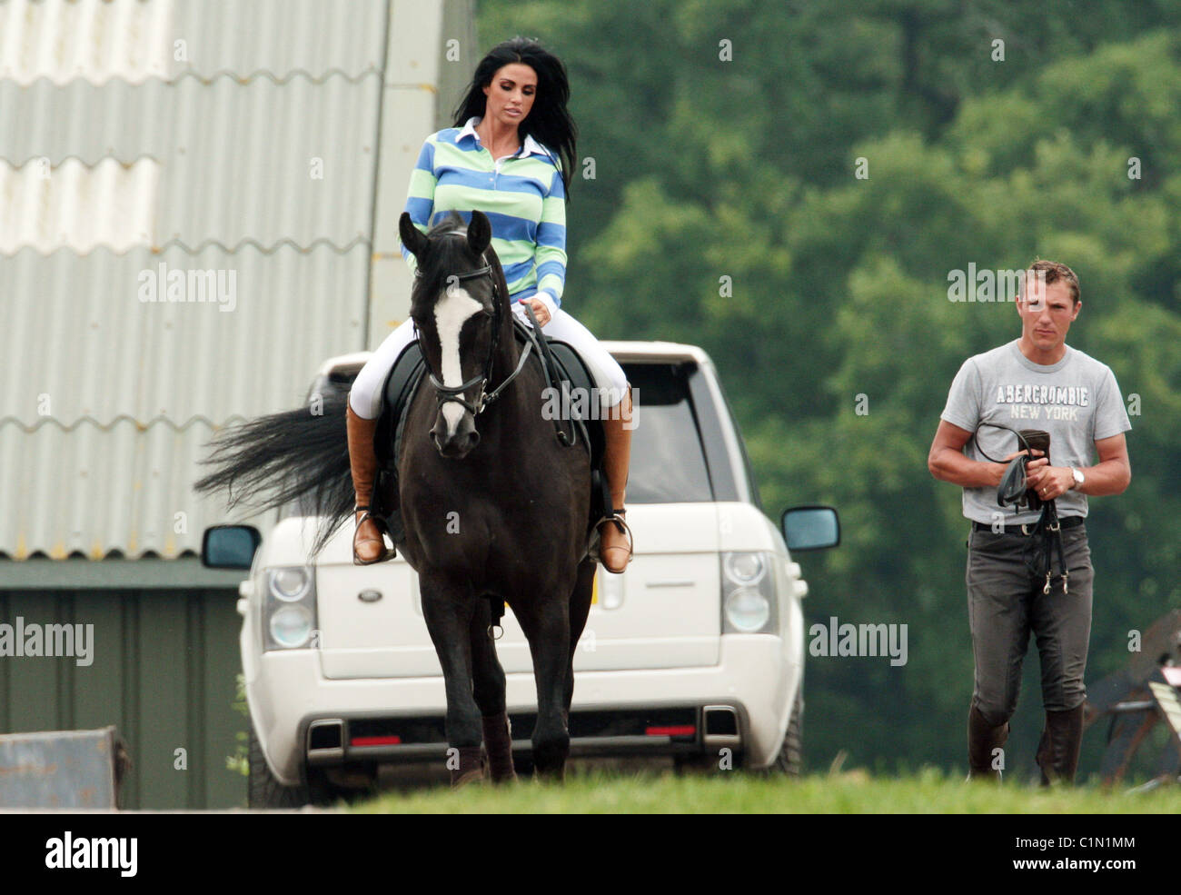Katie Price aka Jordan riding her horse at the stables with her riding  instructor Andrew Gould East Sussex, England - 26.06.09 Stock Photo - Alamy