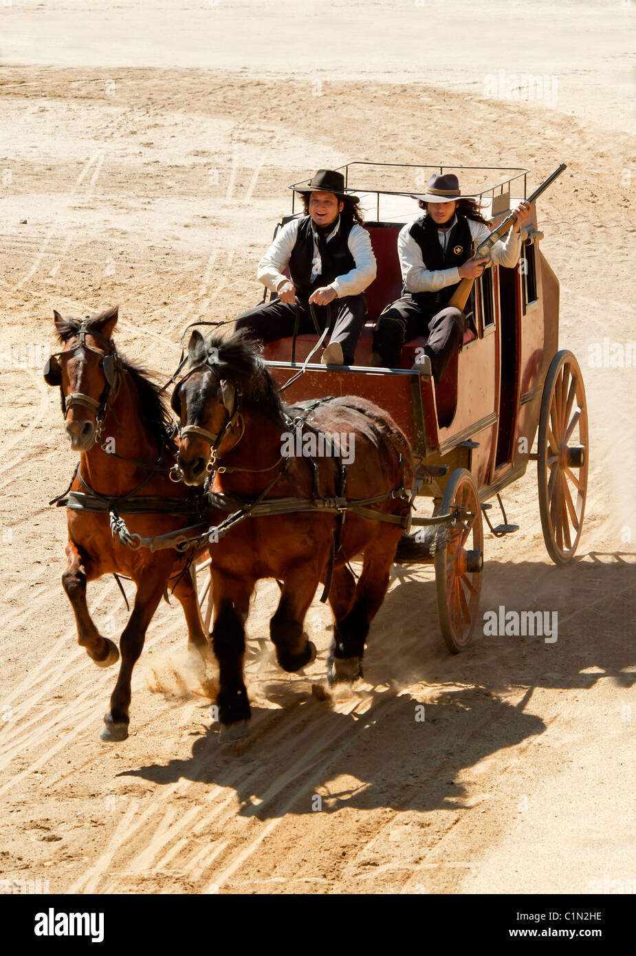 Sheriff and Deputy driving a stagecoach at speed on a movie set at Mini Hollywood, Almeria, Andalusia, Spain Stock Photo