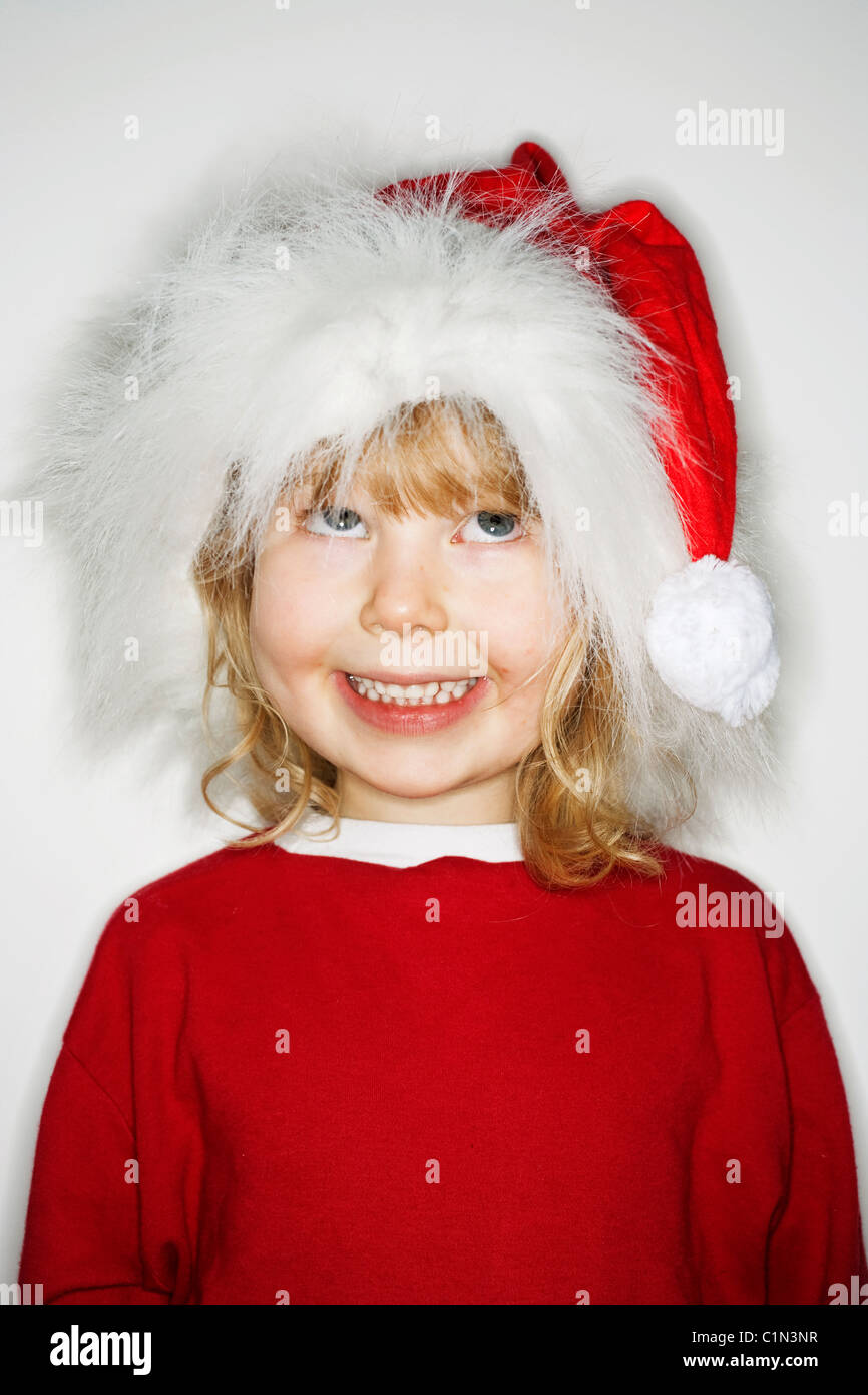 Girl wearing santa hat, looking up Stock Photo Alamy