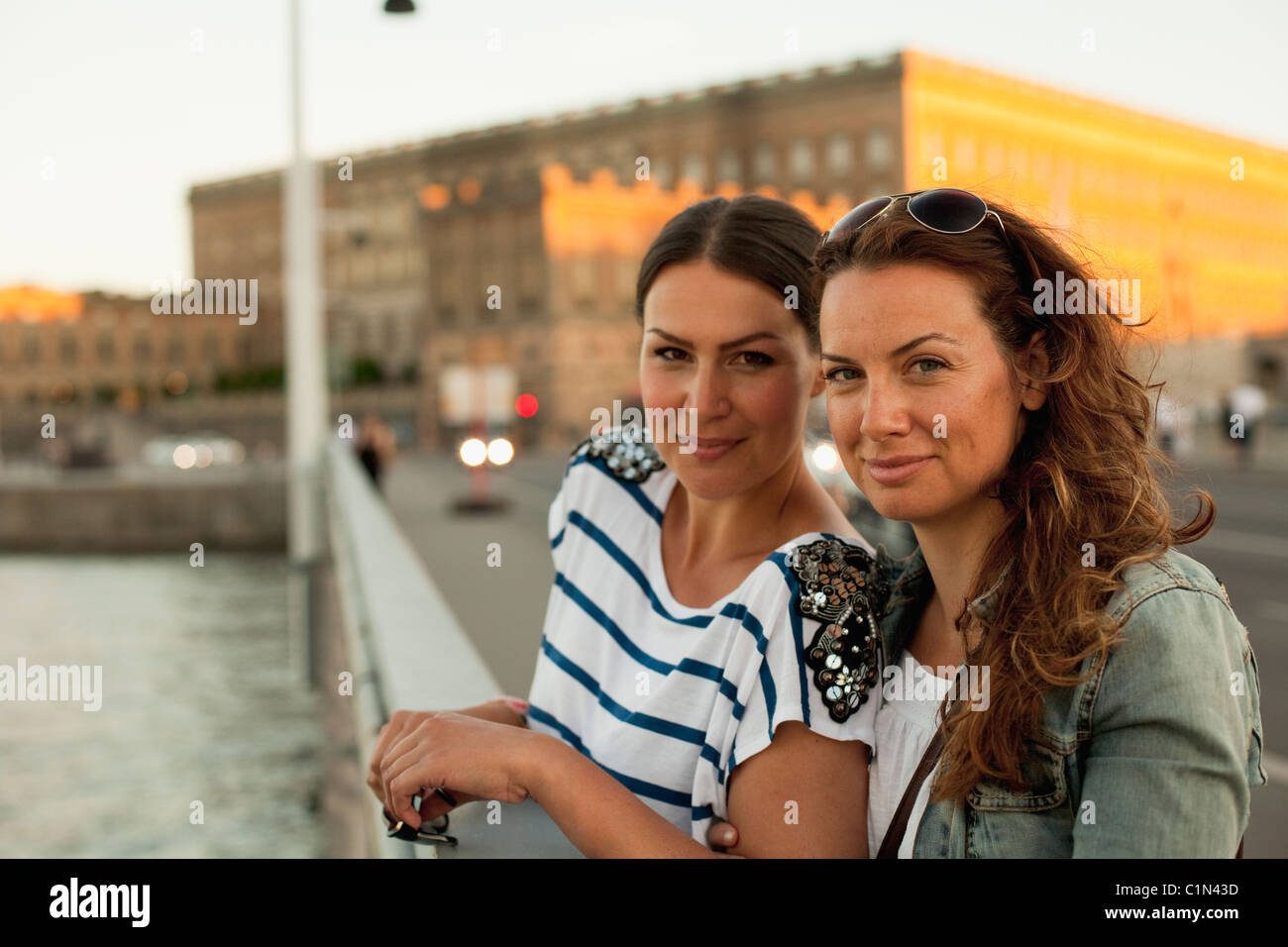 Two women standing on bridge Stock Photo - Alamy
