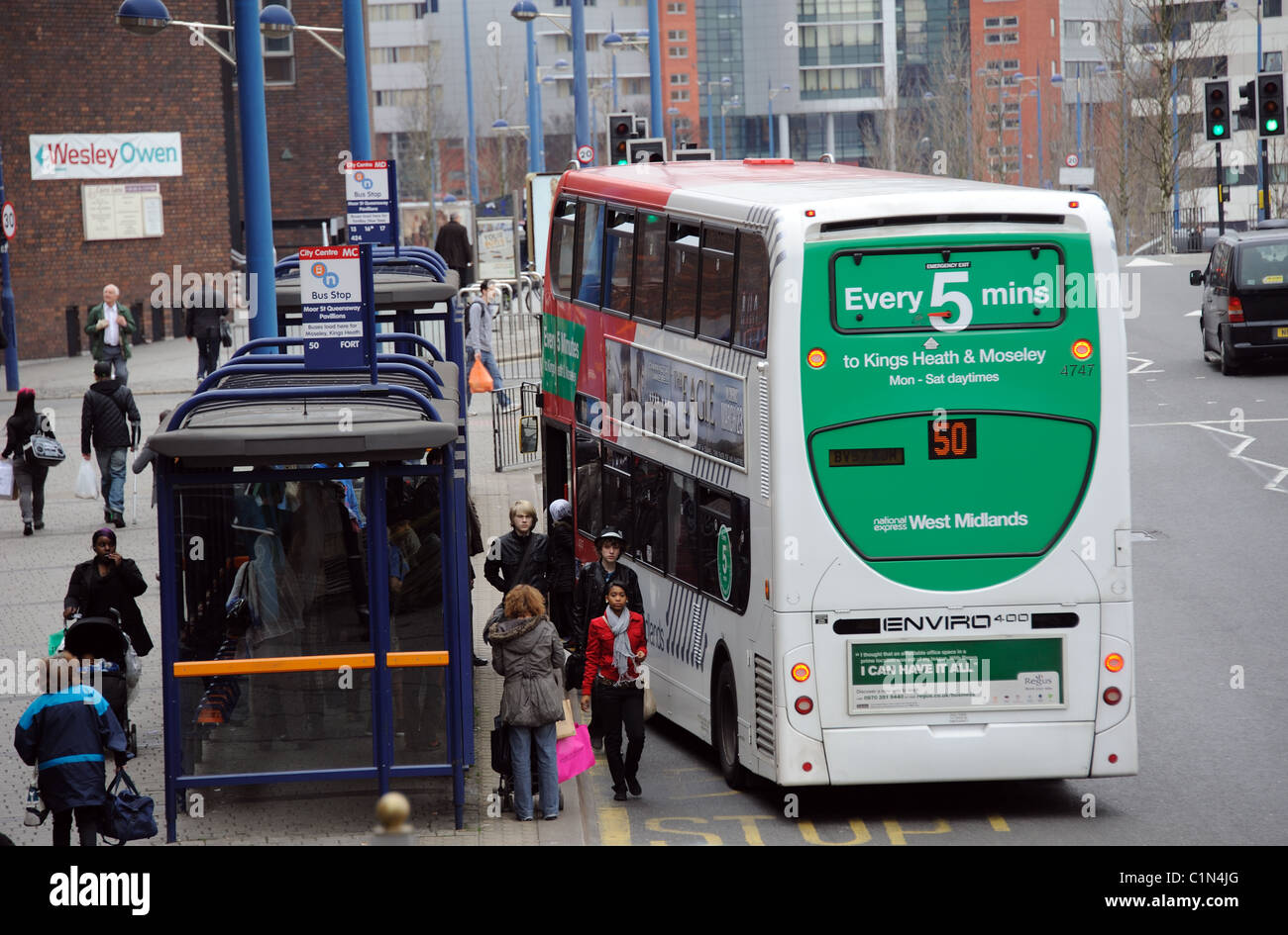 Birmingham city centre buses on Moor Street close to The Bullring shopping centre Bus stop and passengers Stock Photo