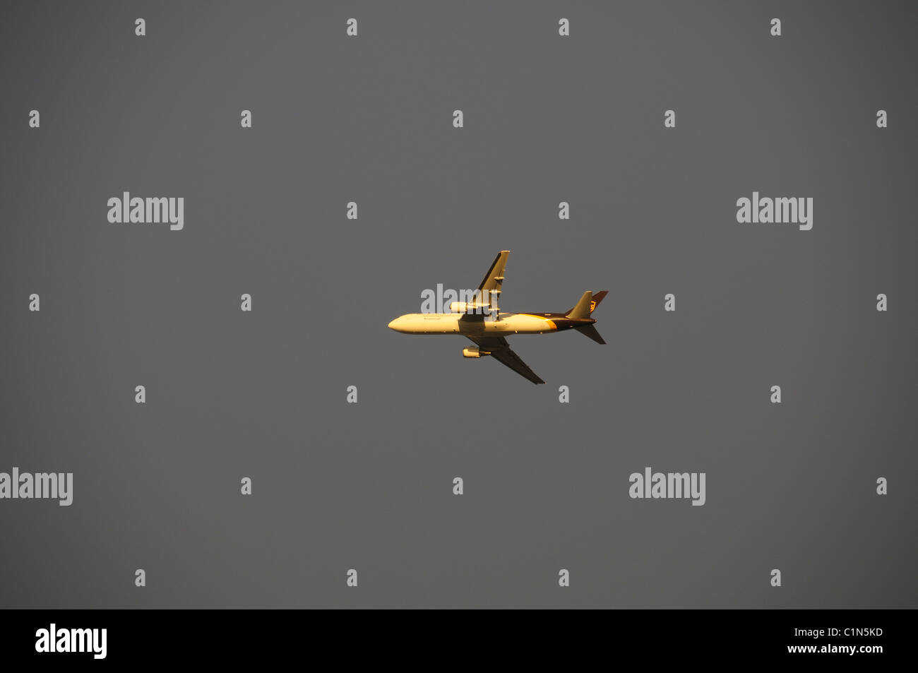Plane flying on a blue sky Stock Photo - Alamy