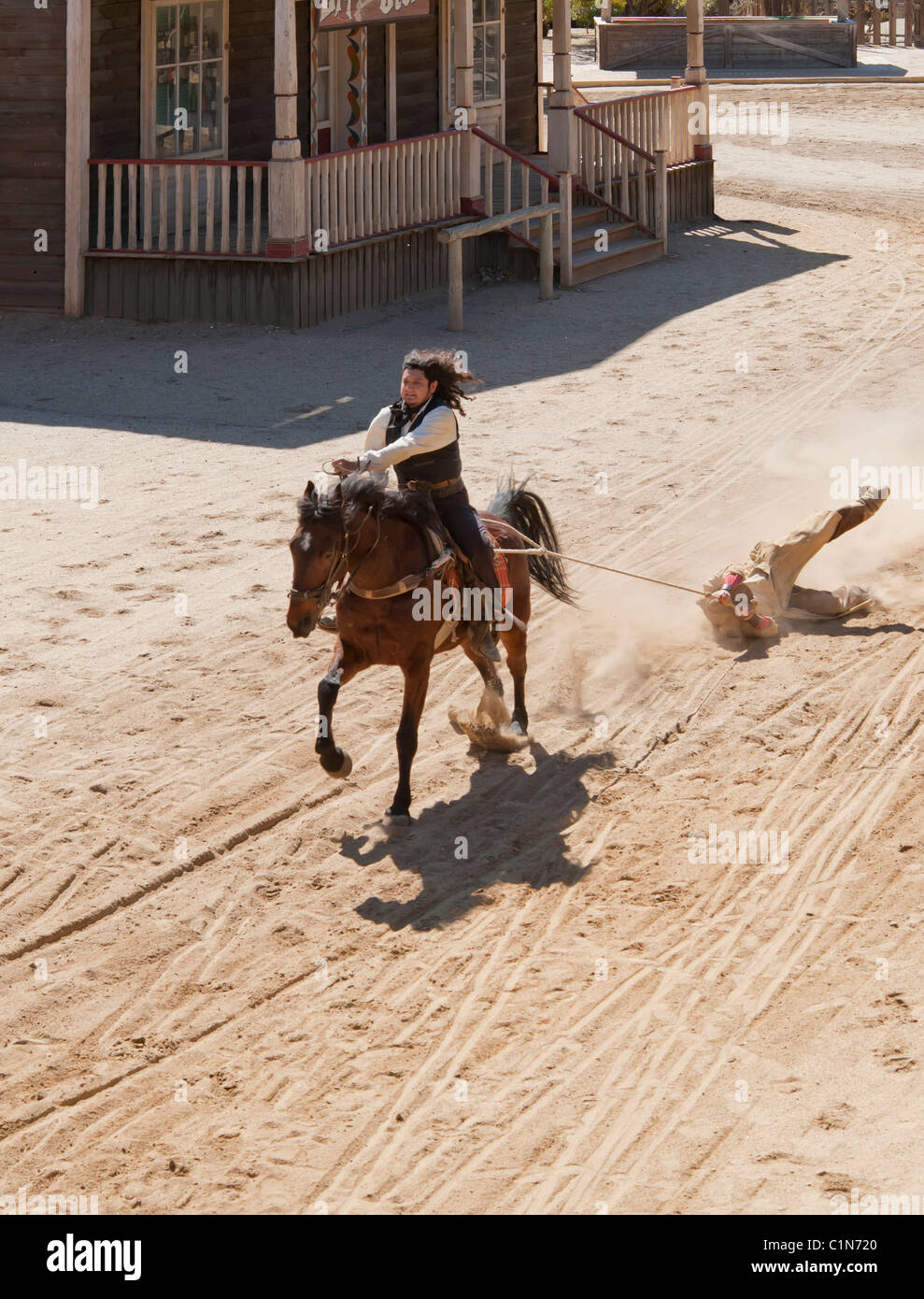 Deputy Sheriff dragging a Bandit by a rope from his horse at Mini Hollywood, Almeria, Andalusia, Spain Stock Photo