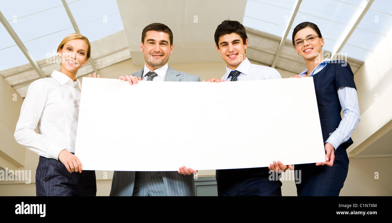 Portrait of group of people holding a white blank Stock Photo - Alamy