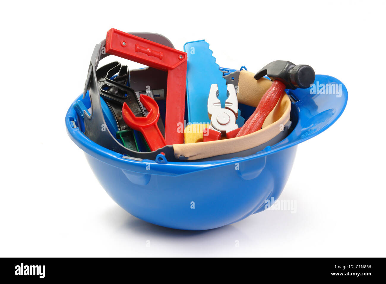 Set of plastic toy tools in blue helmet over white background Stock Photo