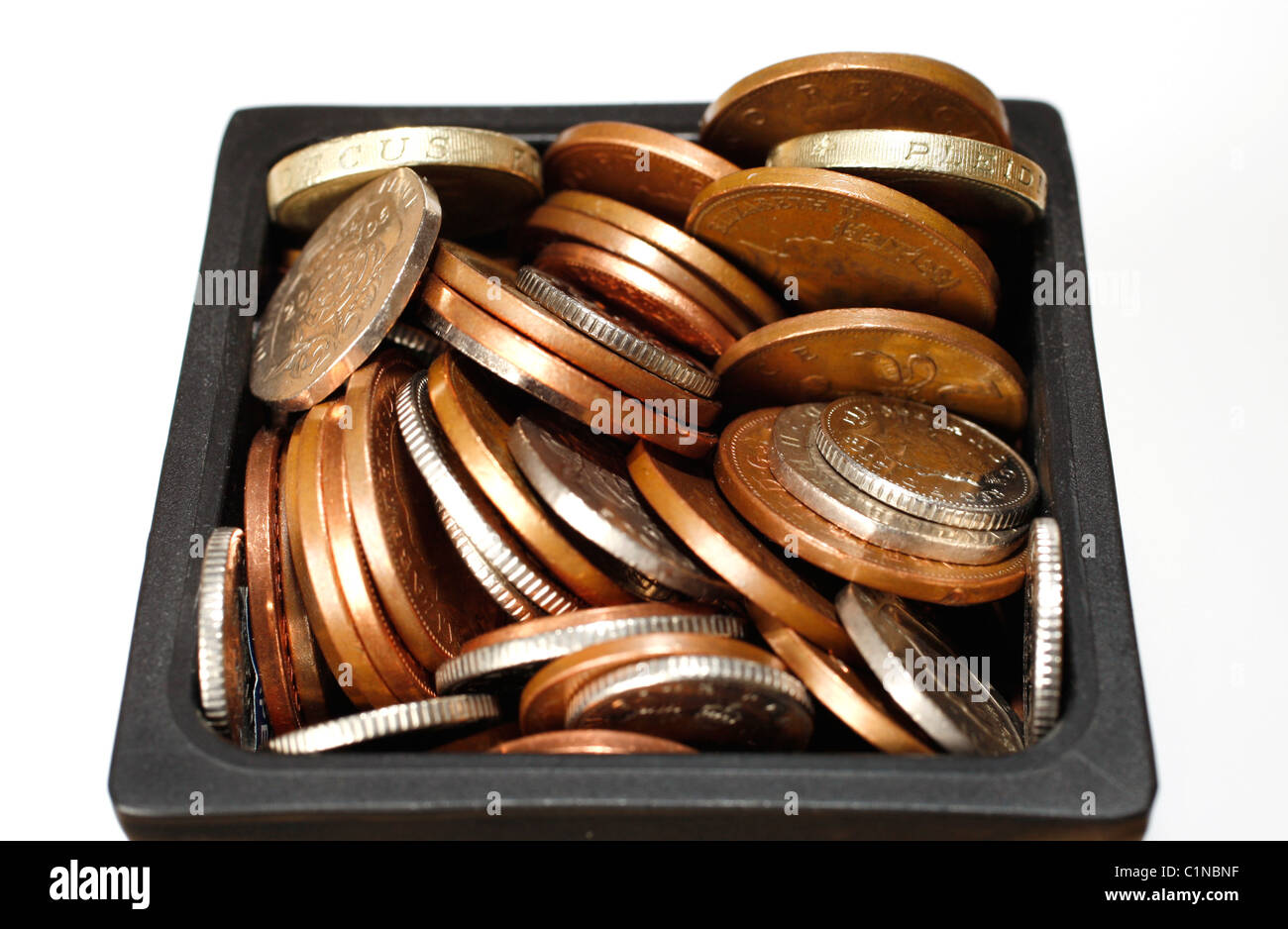 Loose change, money, coins in a pot Stock Photo
