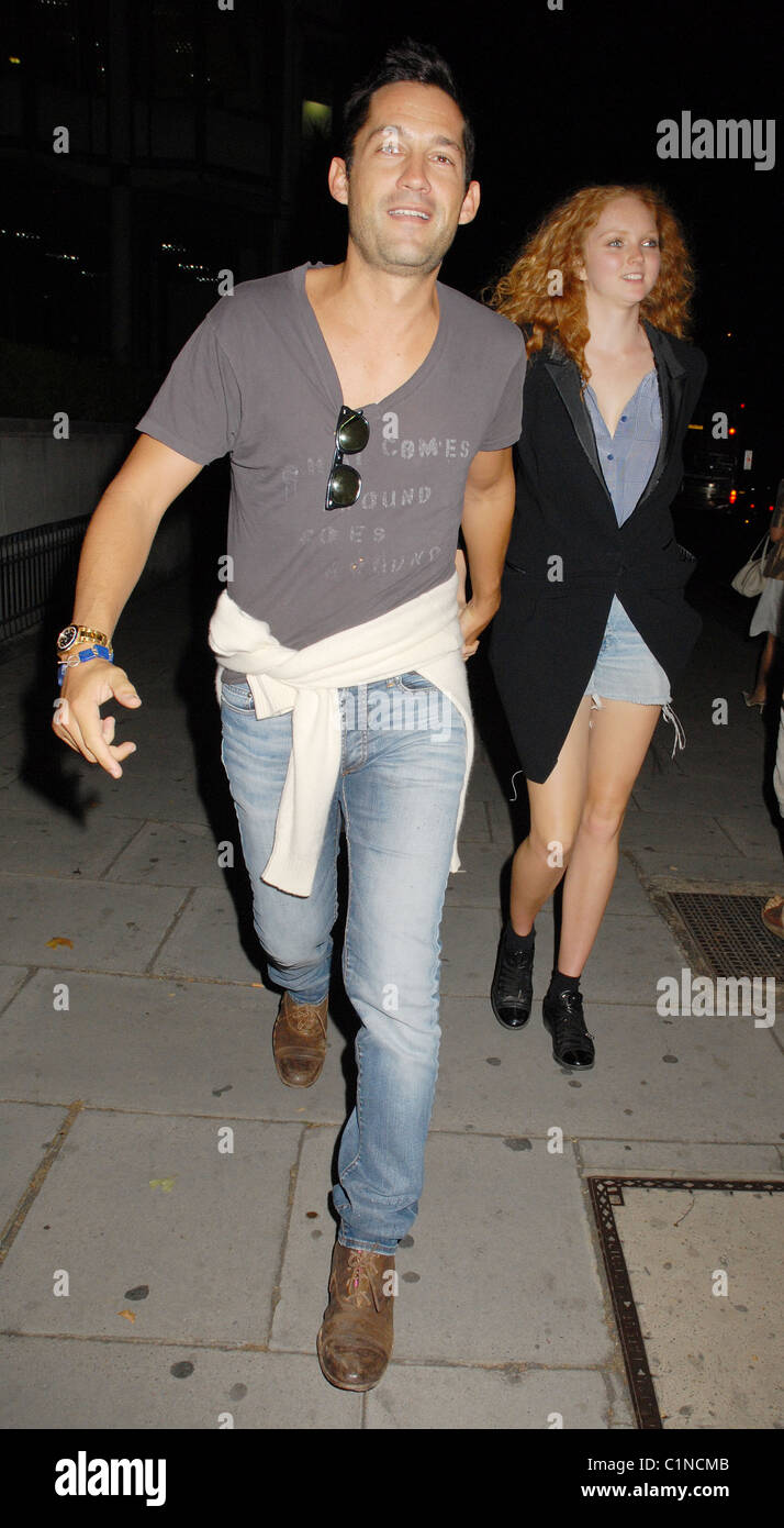 Lily Cole and Enrique Murciano walking along Park Lane London, England